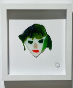 abstract female face with green hair and red lipstick in glass picture frame